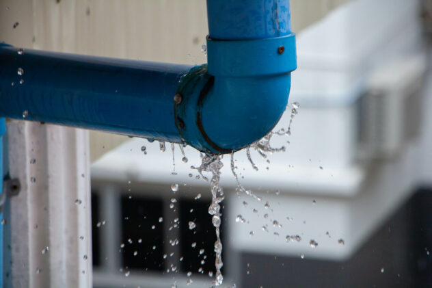 Closeup view of leaked and splash water from the plastic pipe du