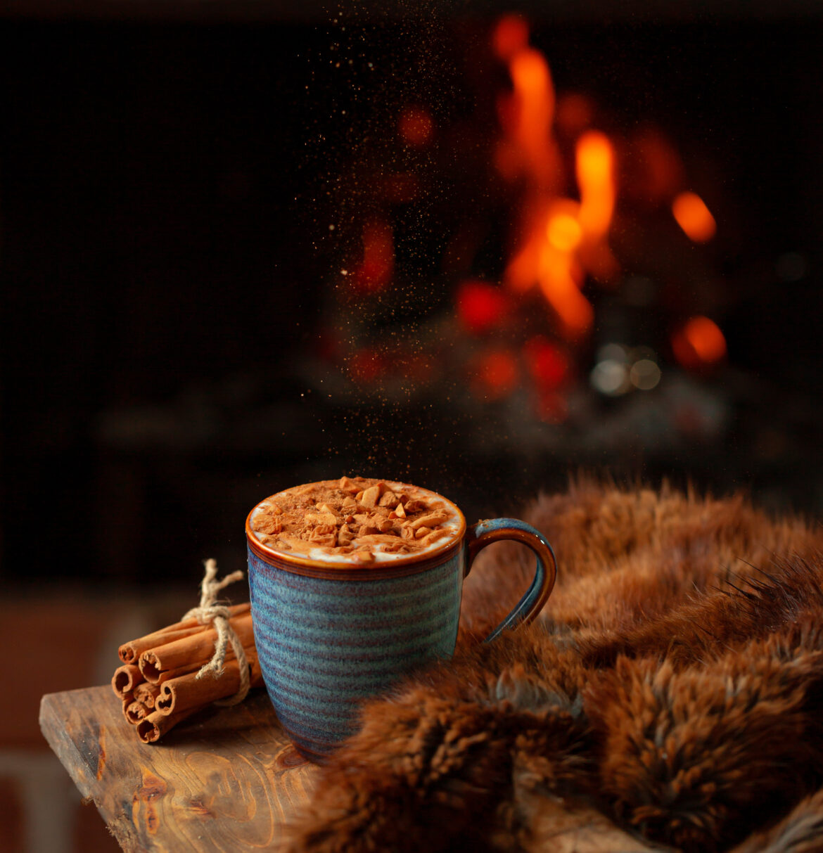 Hot sahlab drink (arabic: سحلب) with cinnamon and fireplace