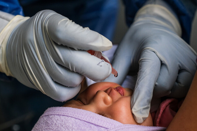 A child receives a polio vaccine during the regular vaccination program at the Batasan Hills Super Health Center in Quezon City, Philippines, on December 15, 2020.